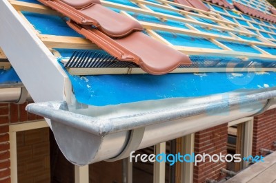 Zinc Gutter And Tiles On Roof Pitch Of House Stock Photo