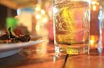 A Glass Of Whiskey And Some Food Stock Photo