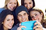 A Group Of Friends Taking Photos With A Smartphone Stock Photo