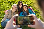 A Group Of Friends Taking Photos With A Smartphone Stock Photo