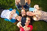 A Group Of Friends Taking Photos With A Smartphone Stock Photo