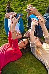 A Group Of Friends Taking Photos With A Smartphone Stock Photo