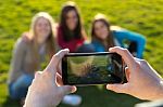 A Group Of Friends Taking Photos With A Smartphone Stock Photo