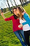 A Group Of Friends Taking Photos With A Smartphone Stock Photo