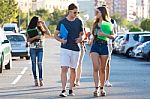 A Group Of Friends Talking In The Street After Class Stock Photo