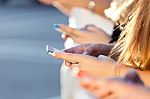 A Group Of Students Having Fun With Smartphones After Class Stock Photo