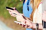 A Group Of Students Having Fun With Smartphones After Class Stock Photo