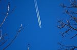 A Long Trail Of Jet Plane On Blue Sky Stock Photo