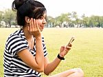 A Young Girl With Headphones Outdoors. Listening Music Stock Photo