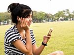 A Young Girl With Headphones Outdoors. Listening Music Stock Photo