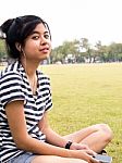 A Young Girl With Headphones Outdoors. Listening Music Stock Photo