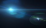 Abstract Blue Lens Flare And Black Background Stock Photo