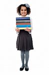 Active School Child Carrying Stack Of Books Stock Photo