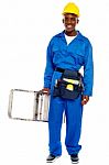 African Builder Holding Step Ladder Stock Photo