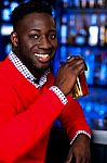 African Guy Drinking Chilled Beer Stock Photo