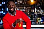 African Guy Posing With Chilled Beer Stock Photo