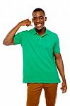 African Guy Showing Call Me Gesture Stock Photo