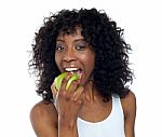 African Lady Eating Apple Stock Photo