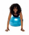 African Lady Lying On Gym Ball Stock Photo