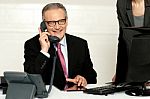 Aged Businessman Communicating On Phone Stock Photo