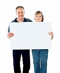 Aged Couple Holding Blank Board Stock Photo