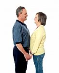 Aged Couple Holding Hands With Love Stock Photo