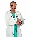 Aged Doctor Holding Clipboard Stock Photo