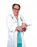 Aged Doctor Holding Clipboard Stock Photo