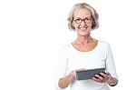 Aged Lady Operating Touch Pad Device Stock Photo