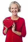 Aged Woman Holding A Red Valentine Gift Box Stock Photo