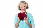 Aged Woman Symbolizing Love, Holding Gift Stock Photo