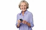 Aged Woman Texting On Her Mobile Phone Stock Photo
