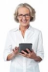 Aged Woman Using Touch Pad Device Stock Photo