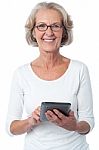 Aged Woman With Touch Pad Device Stock Photo