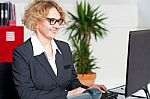 Aged Woman Working On Computer Stock Photo