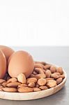 Almond Nuts And Eggs On Wooden Plate Stock Photo