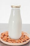 Almond Nuts On Wooden Plate With Milk Stock Photo