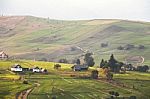 Alpine Village In Mountains. Smoke And Haze Over Hills Stock Photo