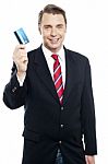 An Entrepreneur Showing Debit Card To Camera Stock Photo