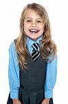 An Excited School Girl In Uniform Wearing Braces Stock Photo