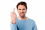 Angry Young Man Showing Middle Finger Stock Photo