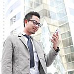 Asia Business Man Using A Mobile Phone Stock Photo