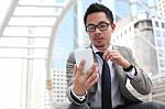 Asia Business Man Using A Mobile Phone Stock Photo