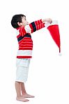 Asian Boy Hold Santa Hat Looking Upwards Stock Photo