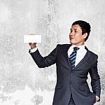 Asian Businessman Showing White Blank Note Stock Photo