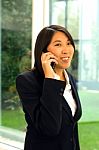 Asian Businesswoman With Mobile Stock Photo