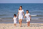 Asian Family On Beach Stock Photo