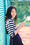 Asian Girl And Computer Tablet In Hand Standing With Toothy Smiling Face Use For People And Internet Connecting ,communication In Modern Digital Lifestyle Stock Photo