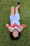 Asian Little Girl Reading Book In The Park Stock Photo