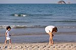 Asian Mom And Son On Beach Stock Photo